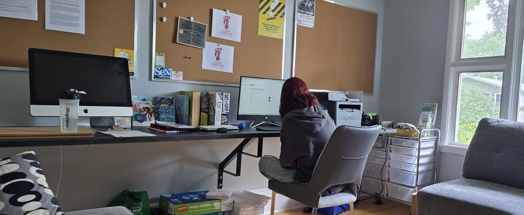 A young person working at a desktop computer in the program's learning space